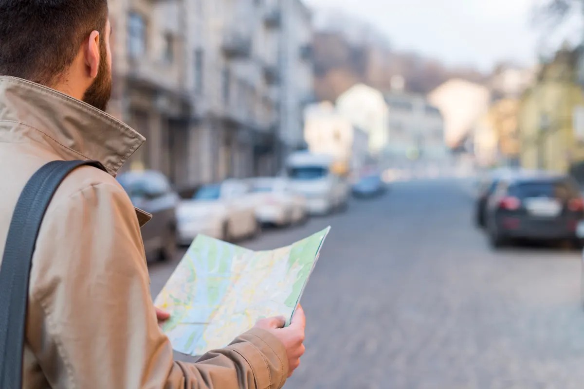 Jobseeker reading a street map while looking for work in a UK city