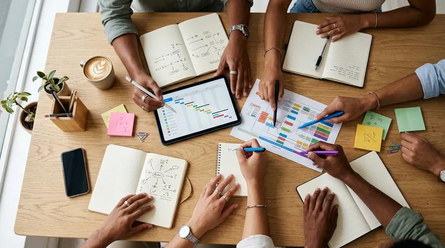 Colleagues planning a hiring schedule around a table